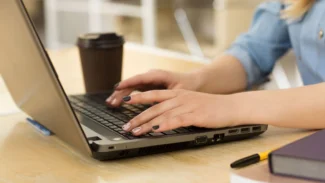 a woman using a laptop computer on a table
