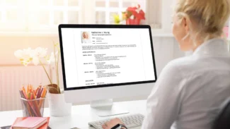 a woman sitting at a desk in front of a computer.