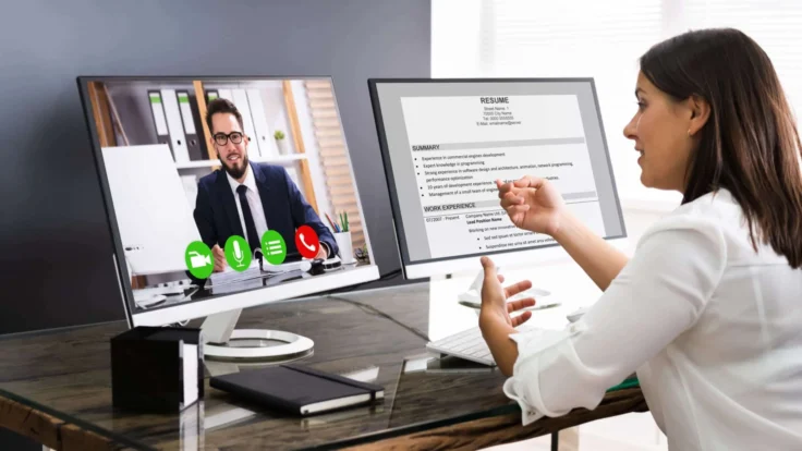 a woman sitting at a desk in front of a computer.