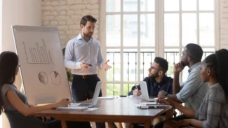 a man giving a presentation to a group of people.
