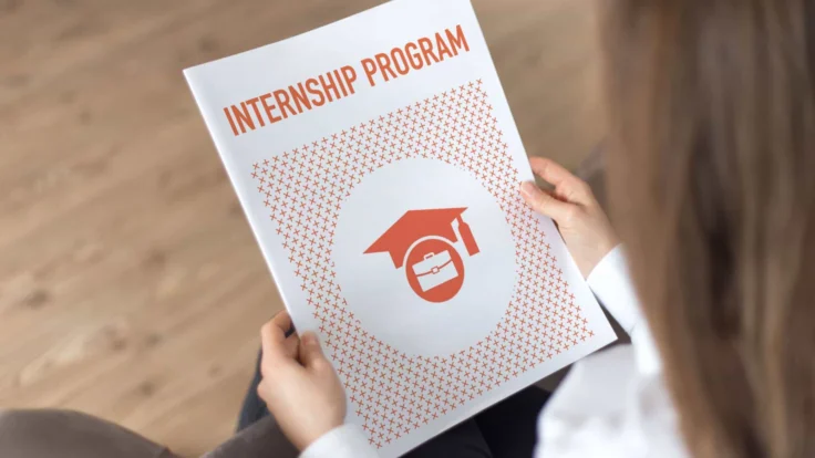 someone holding up a document of an internship program