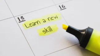 a calendar with the words learn a new skill written on it and a yellow marker